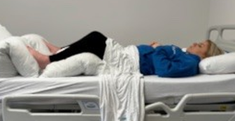 Patient in bed secured on back